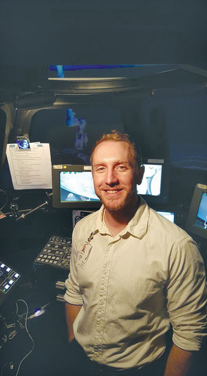 Steven Zusack is shown with a training simulator at the NASA Johnson Space Station in Houston, where he is currently an intern.