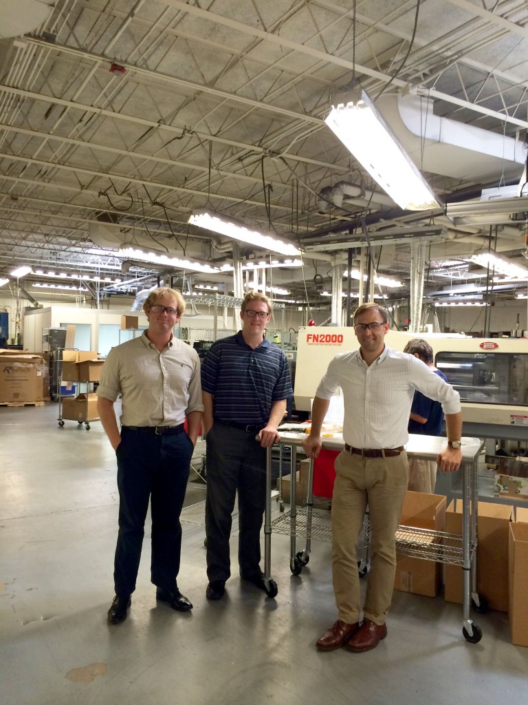 Left to Right: Adam Andrews '12, Stephen Fenton '15, and Andrew Shelton '03 at Paramount in front of their new robotic plastic injection press