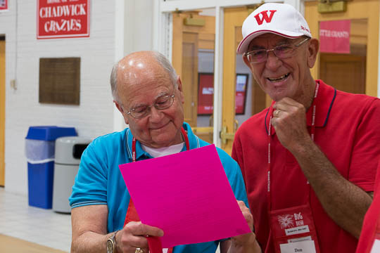 Bob Witherspoon, song leader for the Class of 1965, and Don Schick check out the "subdued" cheat sheets for Old Wabash.