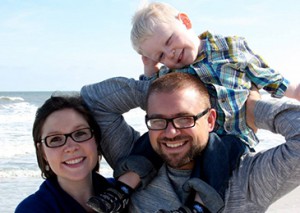 a man and woman with a child on their shoulders