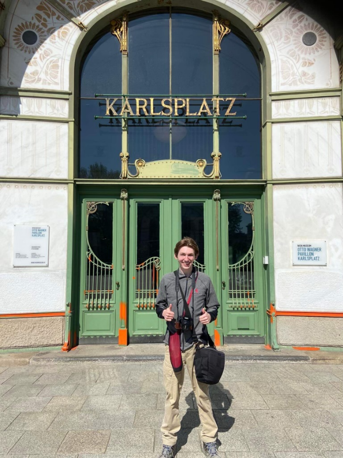 Jacob Monninger stands in front of an iconic Otto Wagner-designed U-Bahn station in Vienna.png