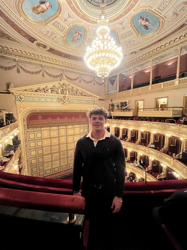 Cole Williams ’27 poses at the National Theatre in Prague
