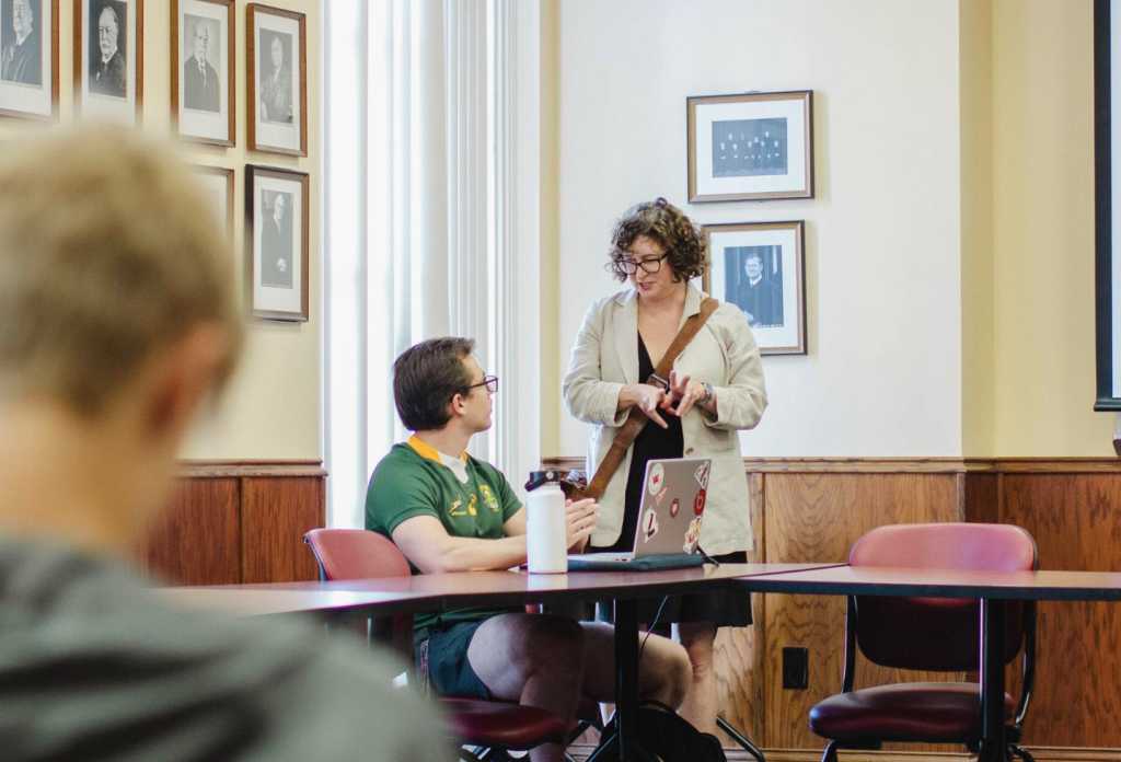 Acero '25 discussing the day's reading with Dr. Crystal Benedicks, one of the English Professors for the WLAIP.