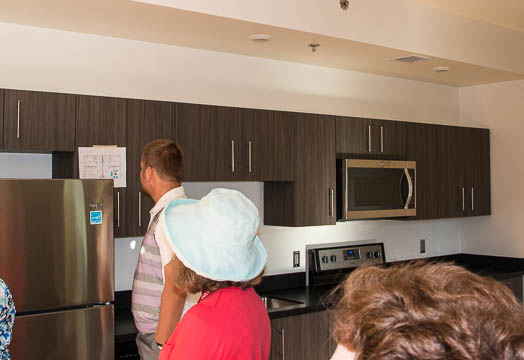 The kitchen features a stove, refrigerator, dish washer, and microwave.